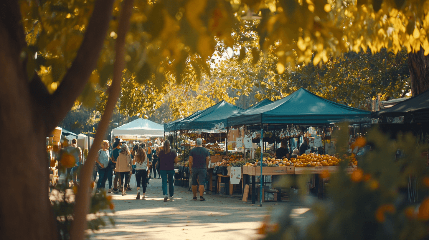 Bustling Drysdale Market with shoppers exploring stalls beneath large trees